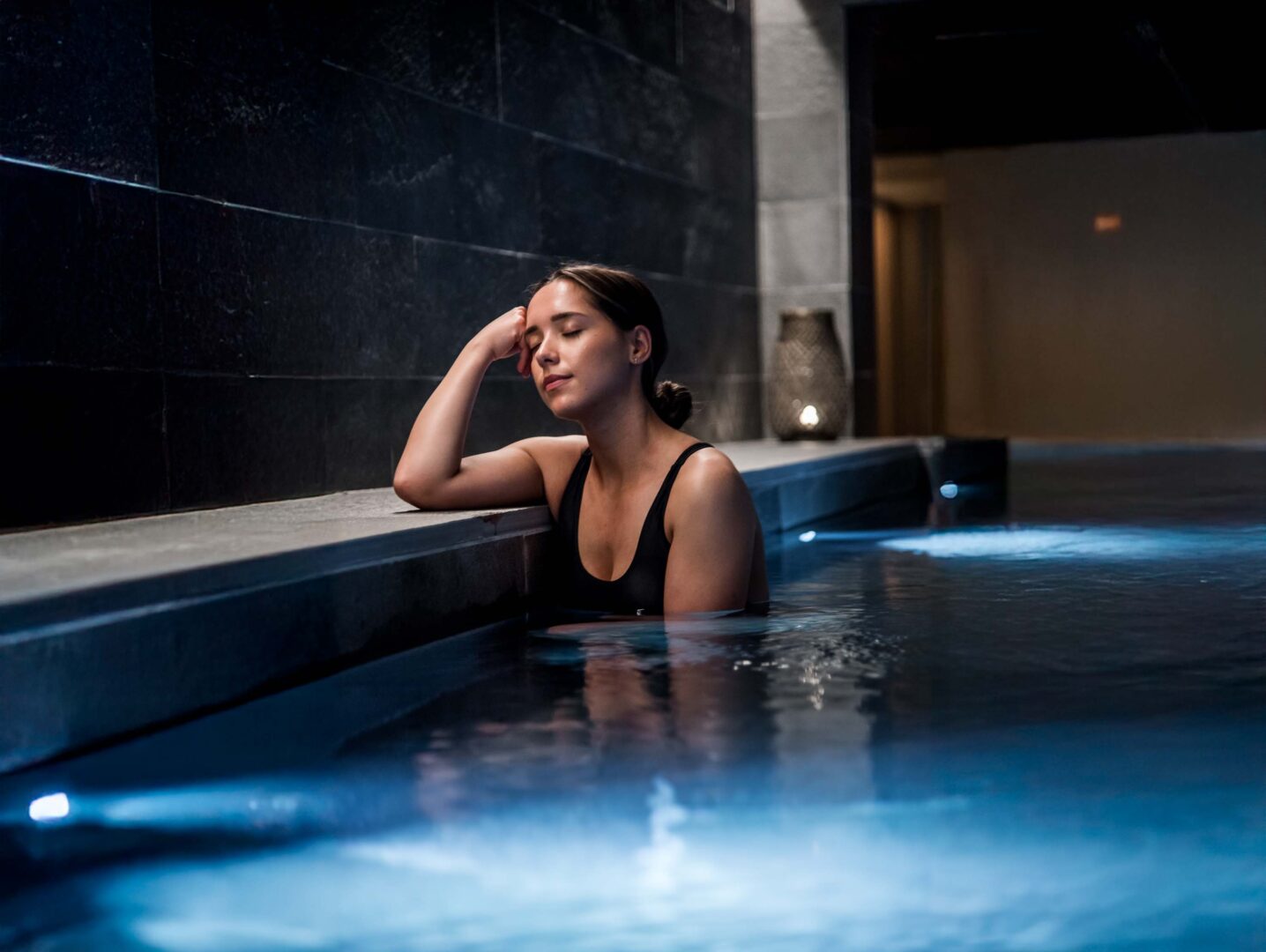 Woman napping in hot spring at Billingehus spa